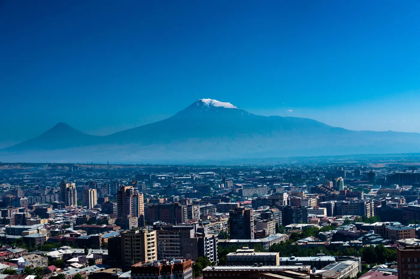 Yerevan spread across the valley floor with the snow cap of Mount Ararat rising behind it