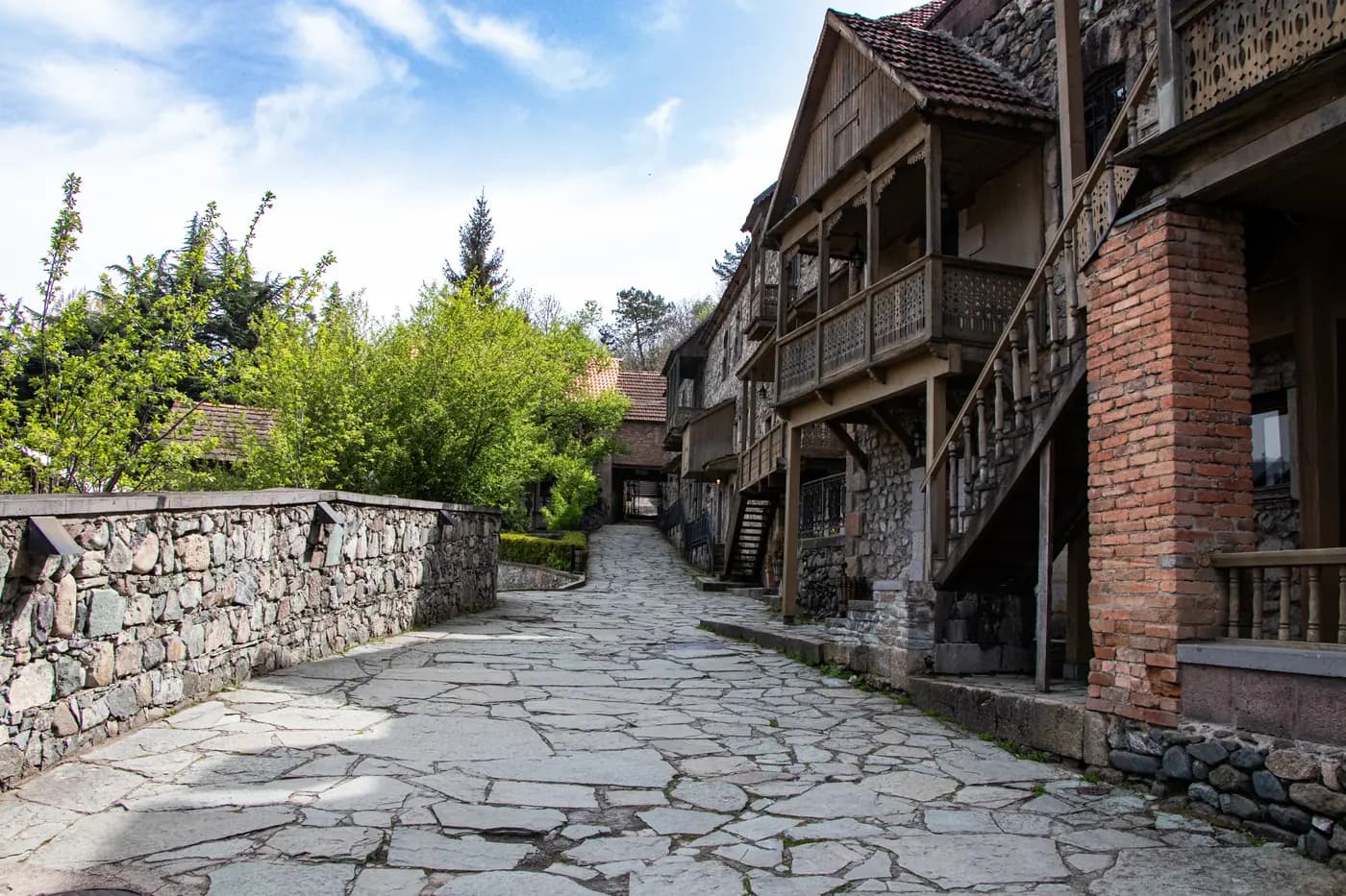 Sharambeyan Street in Dilijan in spring, wooden balconies and stone walls