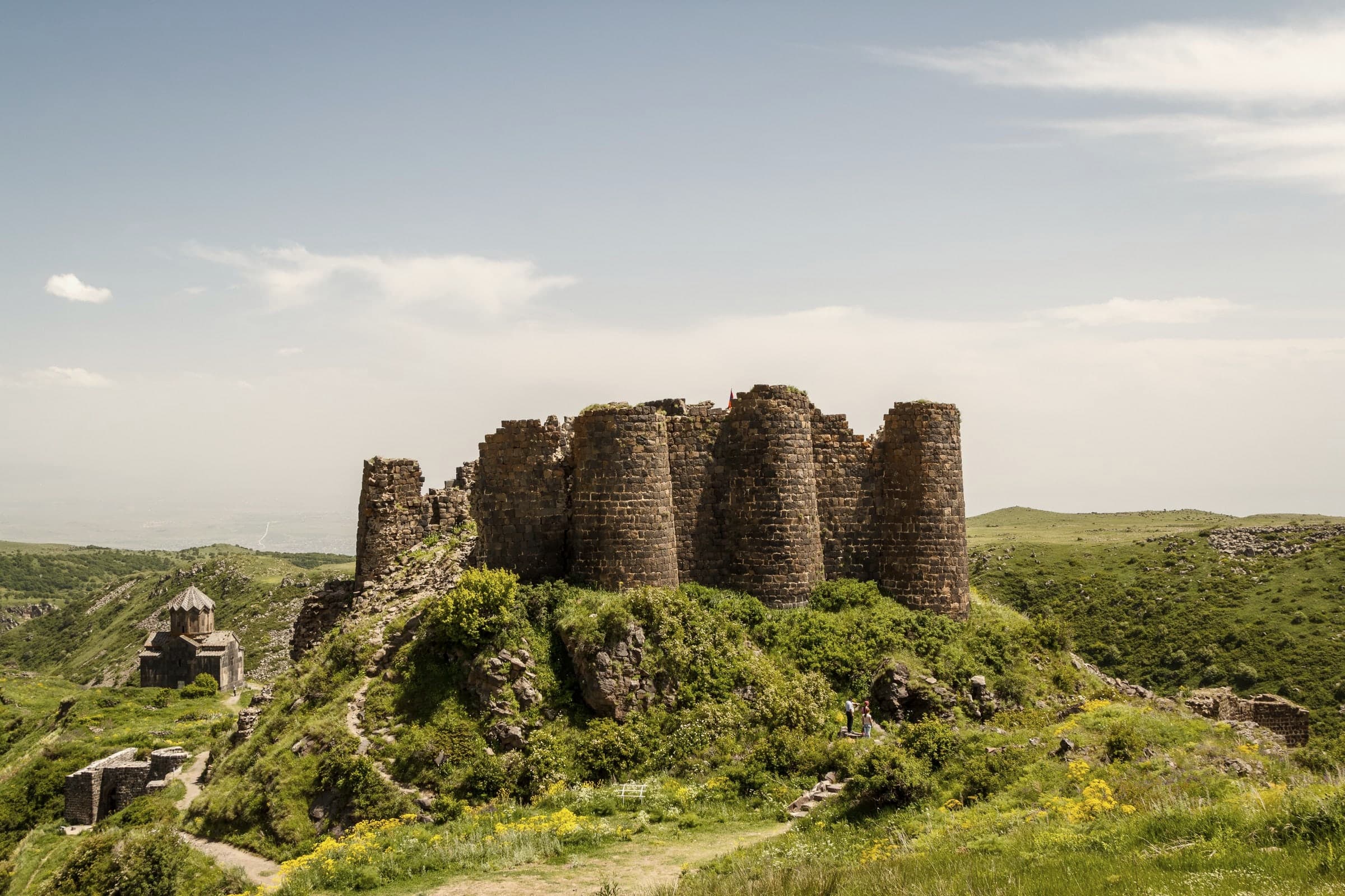 Amberd’s round towers on their green hill, the church of Vahramashen below to the left