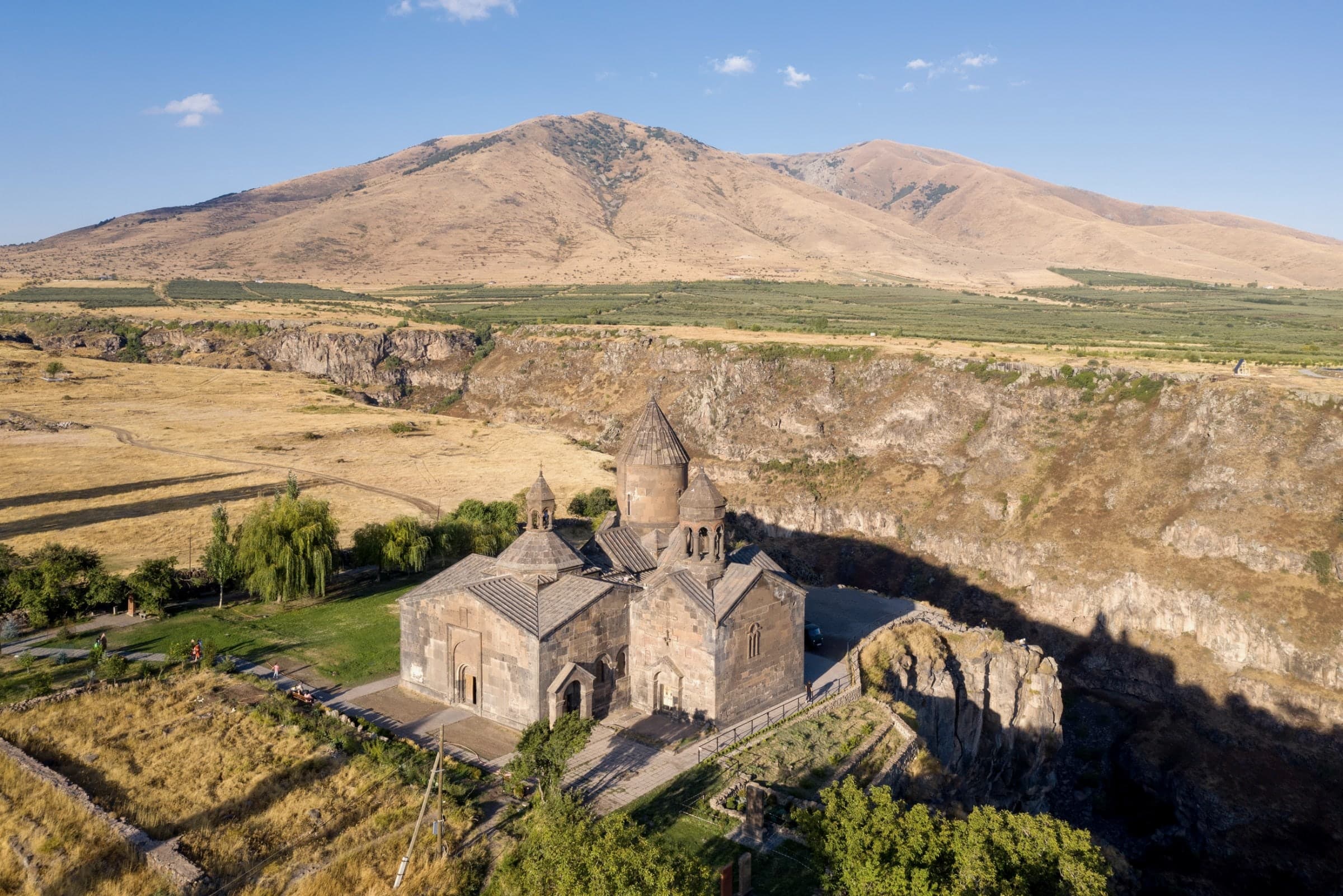 Saghmosavank’s churches on the rim of the Kasakh gorge, the canyon wall falling away in shadow beside them