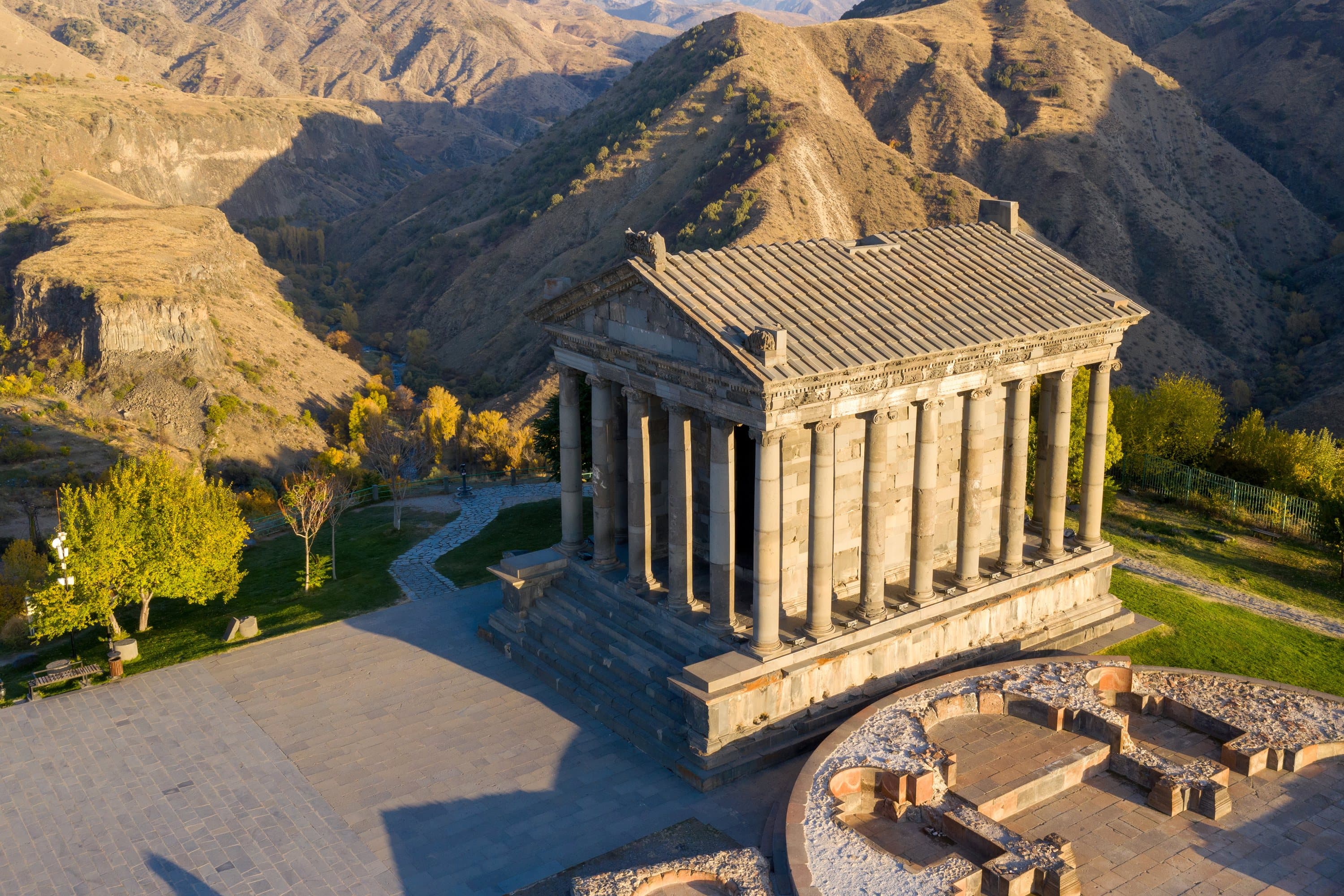 Garni temple from above in low autumn sun, on its spur with the Azat gorge and dry hills falling away behind it