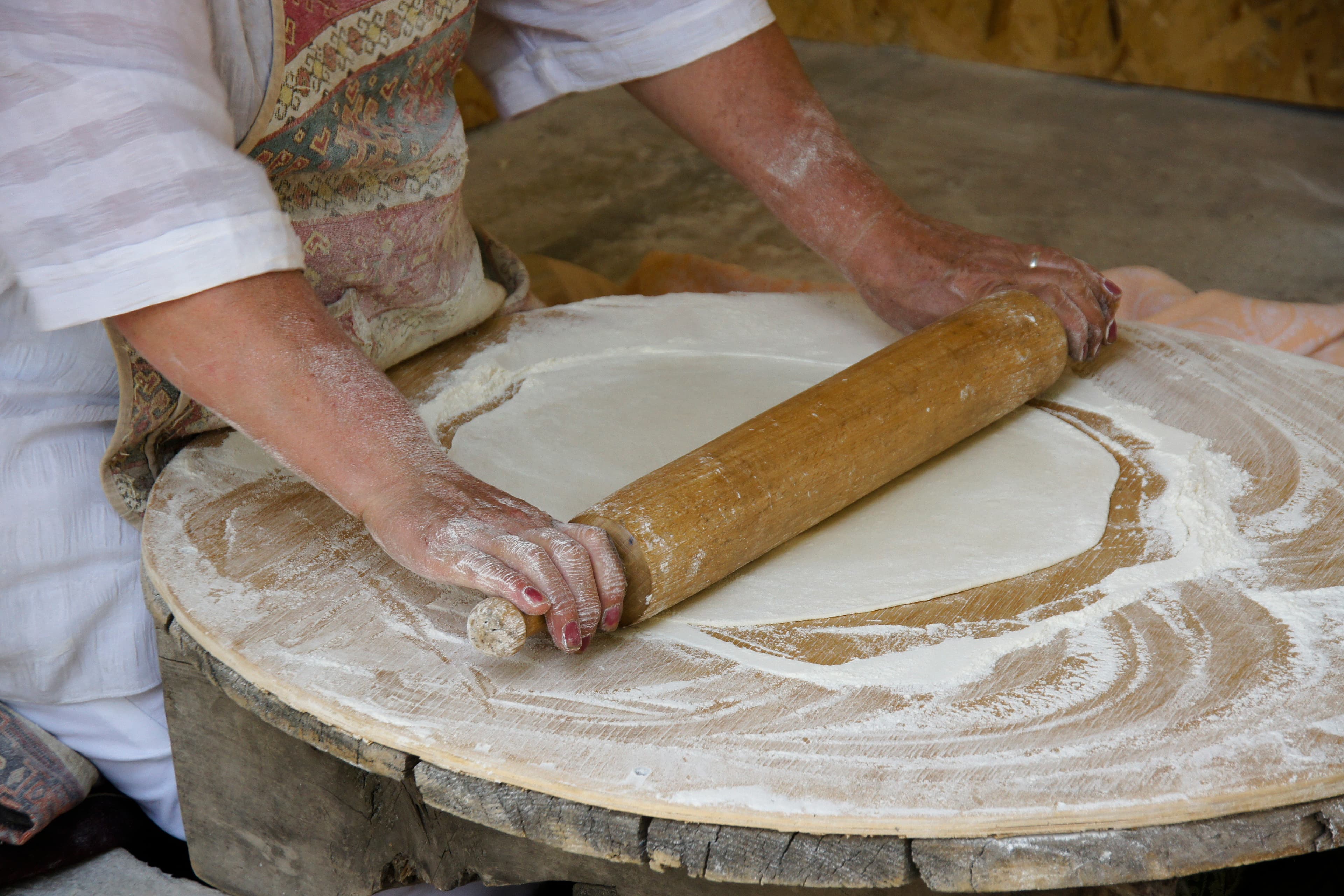 Lavash dough being rolled by hand