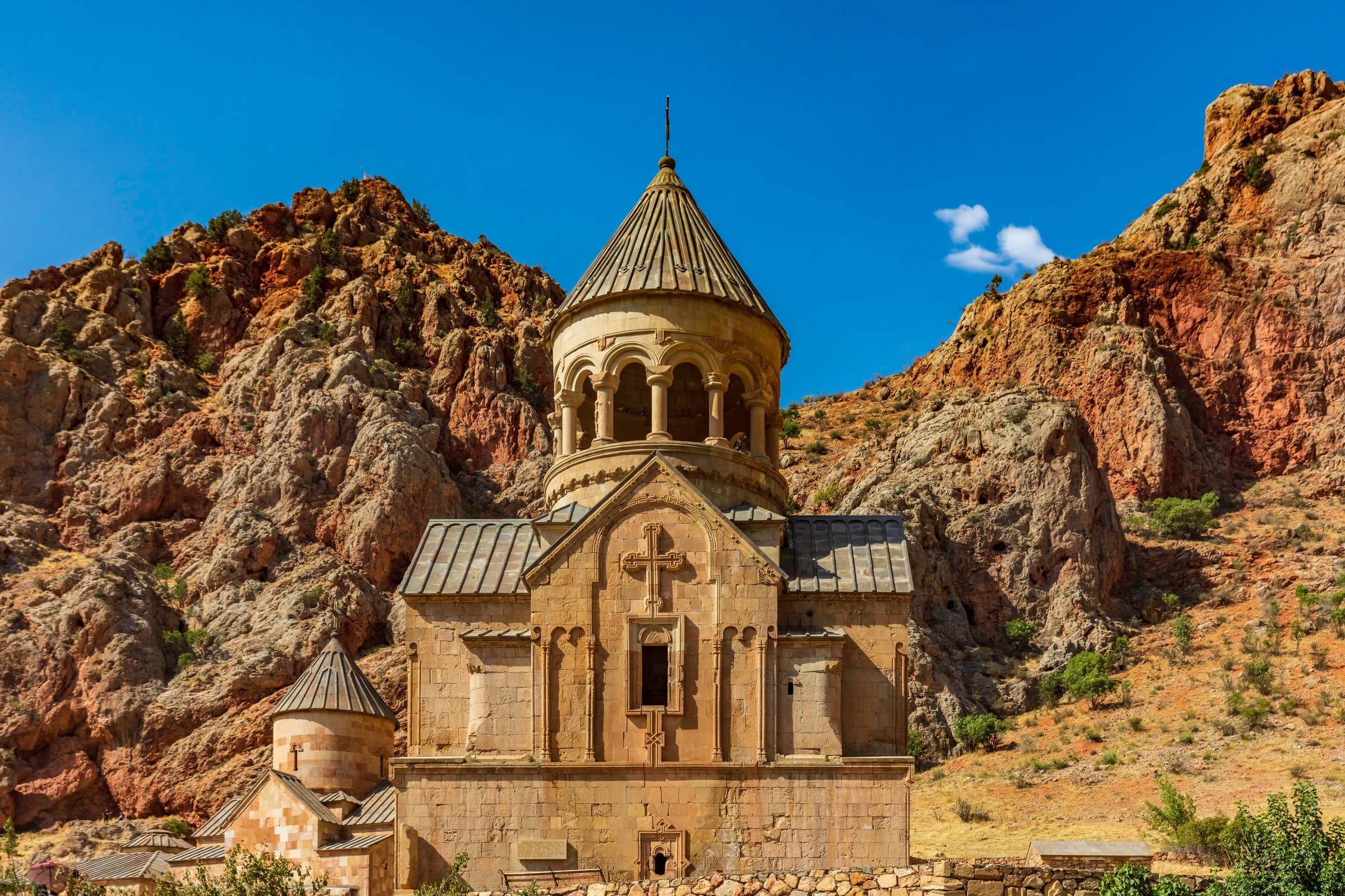 The red and ochre walls of the Noravank canyon closing in on the road