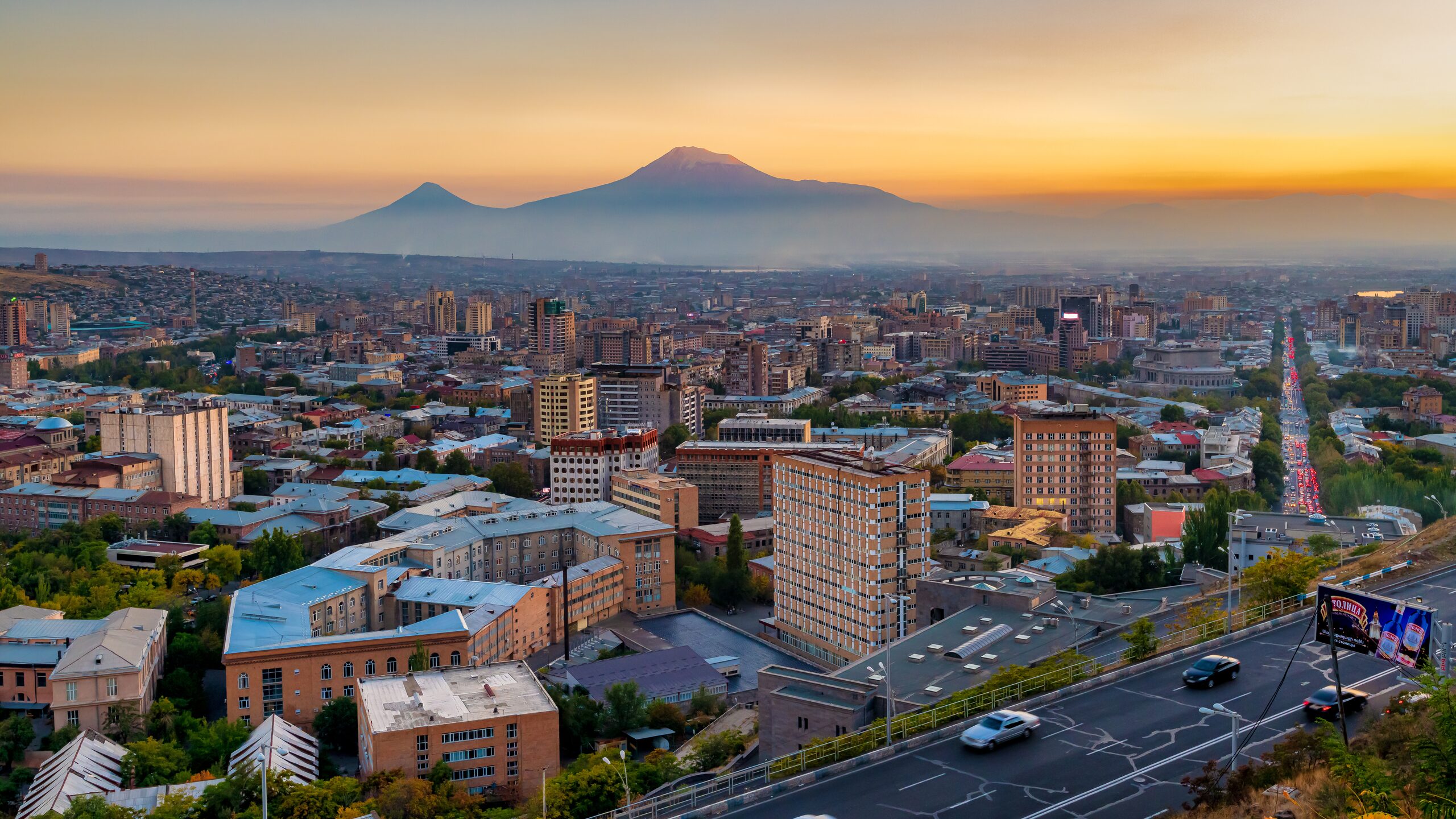 Yerevan at sunset from above, with the two peaks of Ararat across the plain